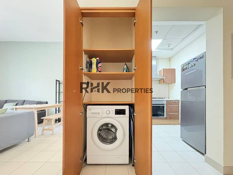 10 Built-in apartment laundry area with front-loading washing machine and storage shelves
