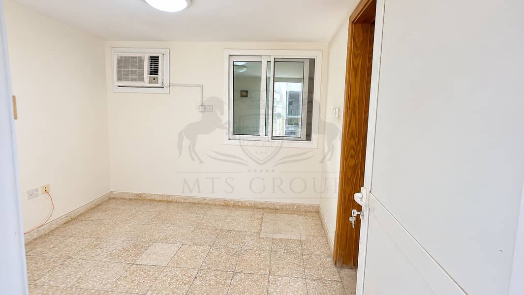 7 Bright Empty Room with Window and AC. png