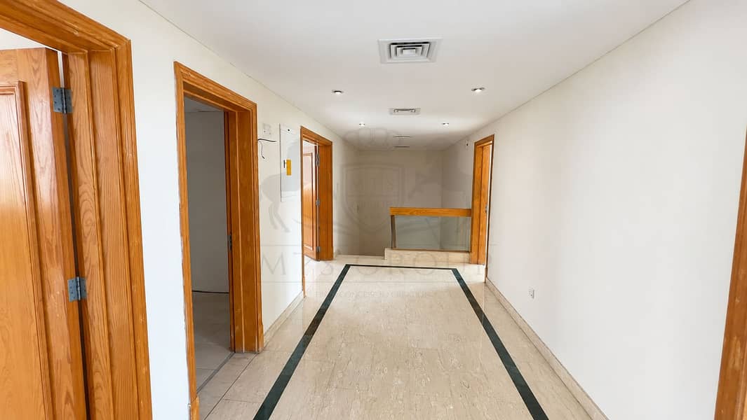 21 Modern Oak-Trimmed Marble Hallway. png