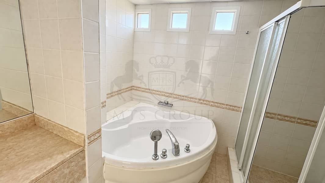 32 Bright Cream-Tiled Corner Bathroom. png