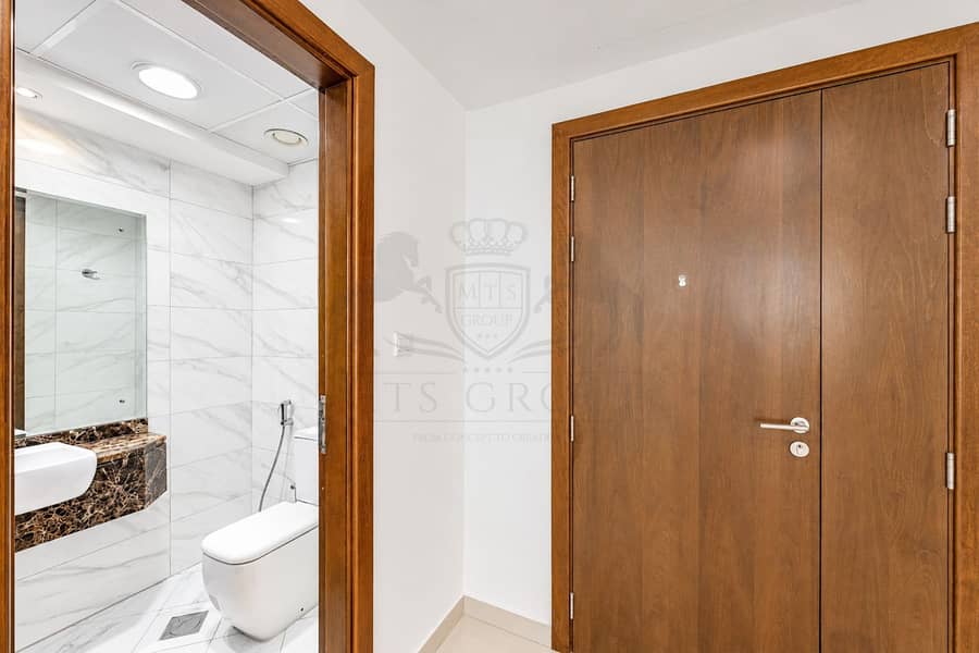 11 Modern Hallway with Marble Bathroom and Wooden Door. png