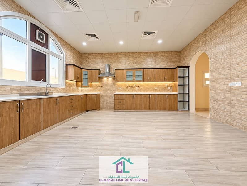 9 Warm Modern Arched-Window Kitchen. png
