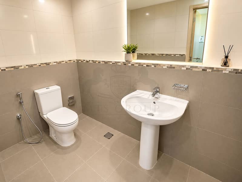 8 Modern Minimalist Bathroom with Warm Backlit Mirror. png