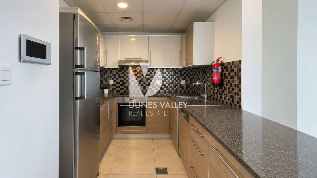 2 Modern Galley Kitchen with Red Fire Extinguisher. png