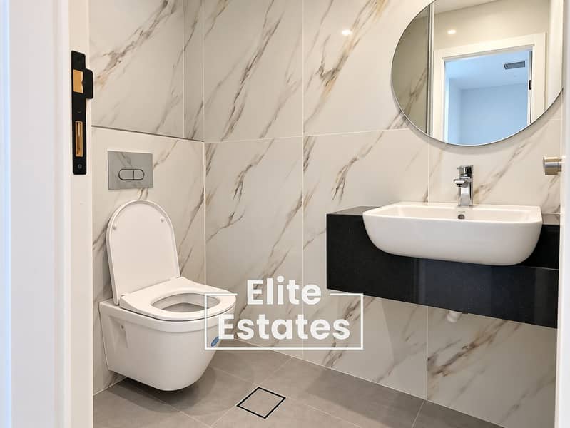 7 Modern Marble-Tiled Bathroom Interior. png