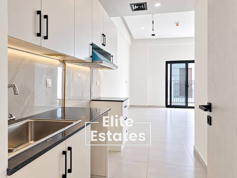 Bright Modern Galley Kitchen with Balcony Views. png Bright Modern Galley Kitchen with Balcony Views. png