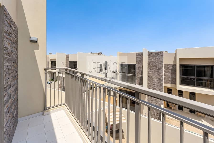 13 Sunlit Modern Balcony Overlooking Townhouses. png