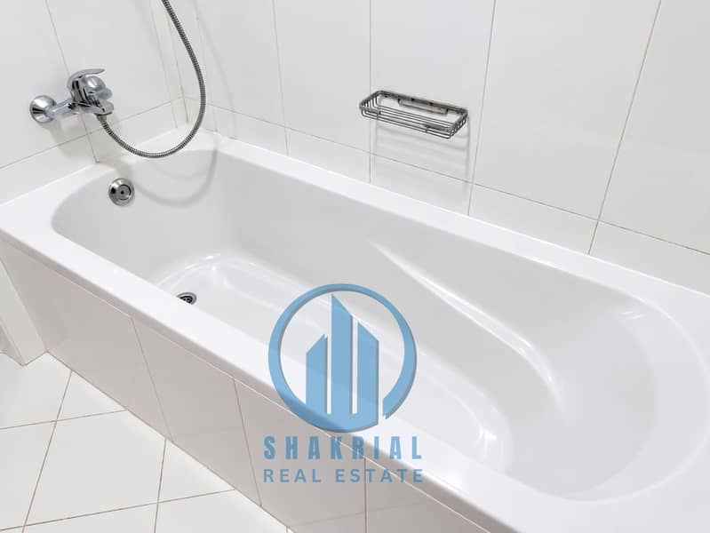 8 Bright Modern White Tiled Bathtub. png