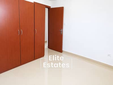شقة 2 غرفة نوم للايجار في المدينة العالمية المرحلة 2 (ورسان 4)، دبي - Minimalist Room with Wooden Wardrobe and Open Door. png
