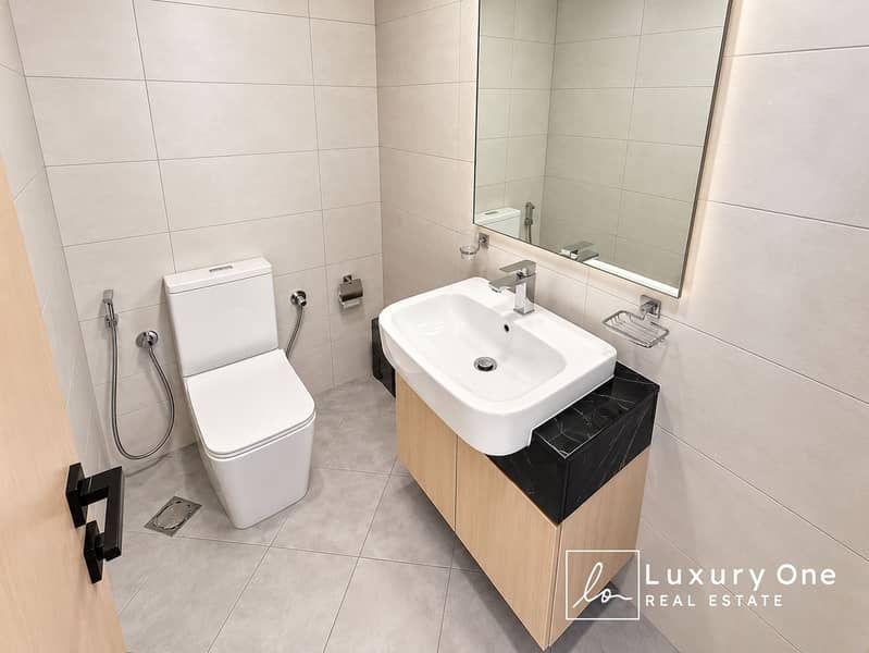 11 Modern Beige-Tiled Bathroom with Floating Vanity (1). png
