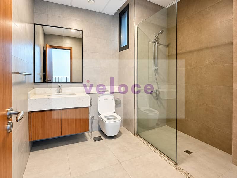 9 Modern Beige-Tile Bathroom with Wood Vanity. png