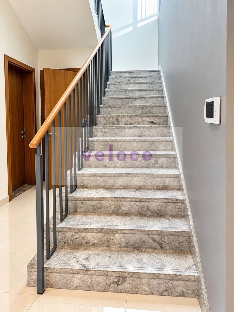 12 Modern Marble Stairway with Warm Wood Accents. png