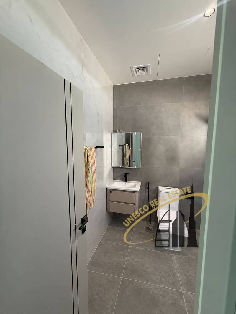 18 Narrow Gray-Tiled Bathroom Cleanup-4. png