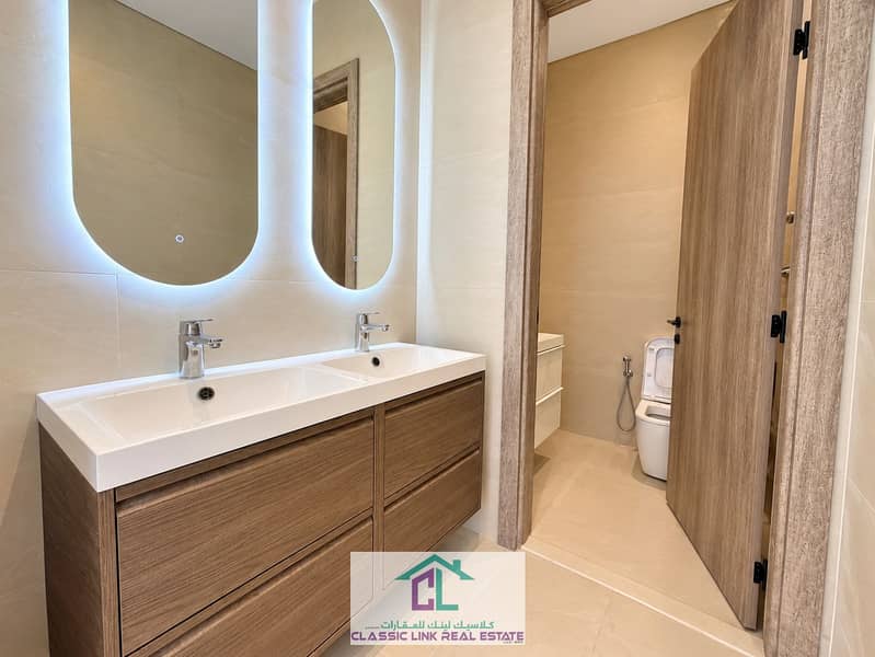 7 Modern Beige Bathroom with Backlit Mirrors. png