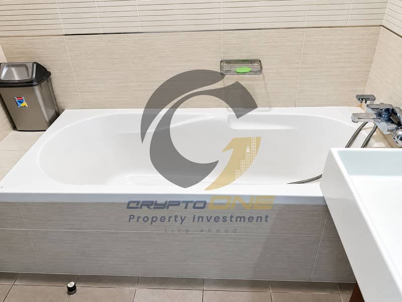22 11_modern_beige_tiled_bathroom_with_bathtub. png