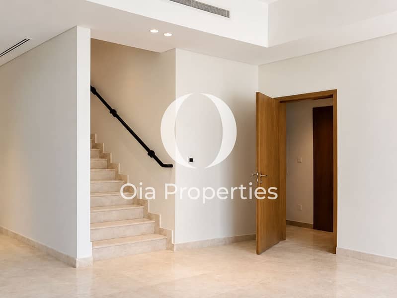 6 Minimalist Marble Foyer with Open Oak Door. png