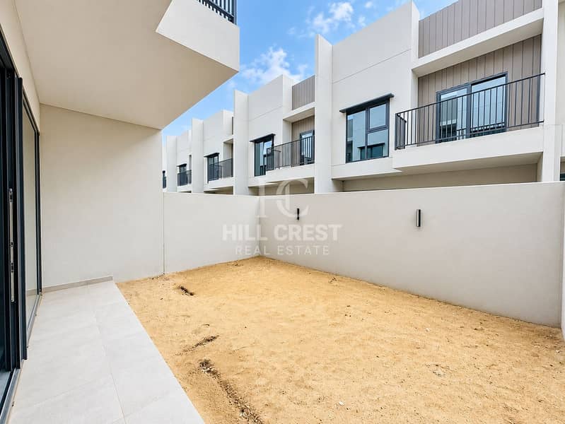 7 Modern Townhouse Courtyard Under Blue Skies. png