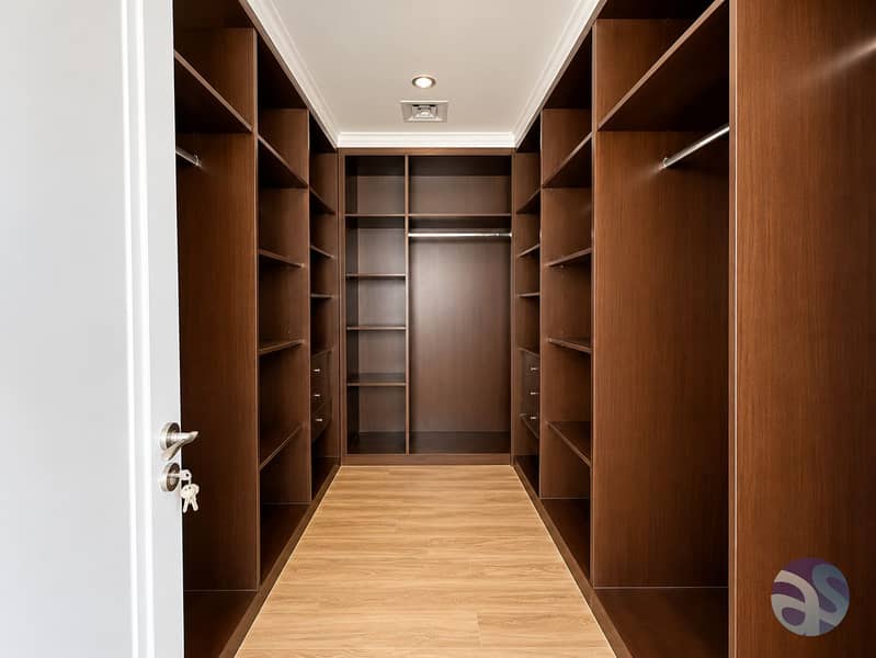 15 Symmetrical Walnut Walk-In Closet. png