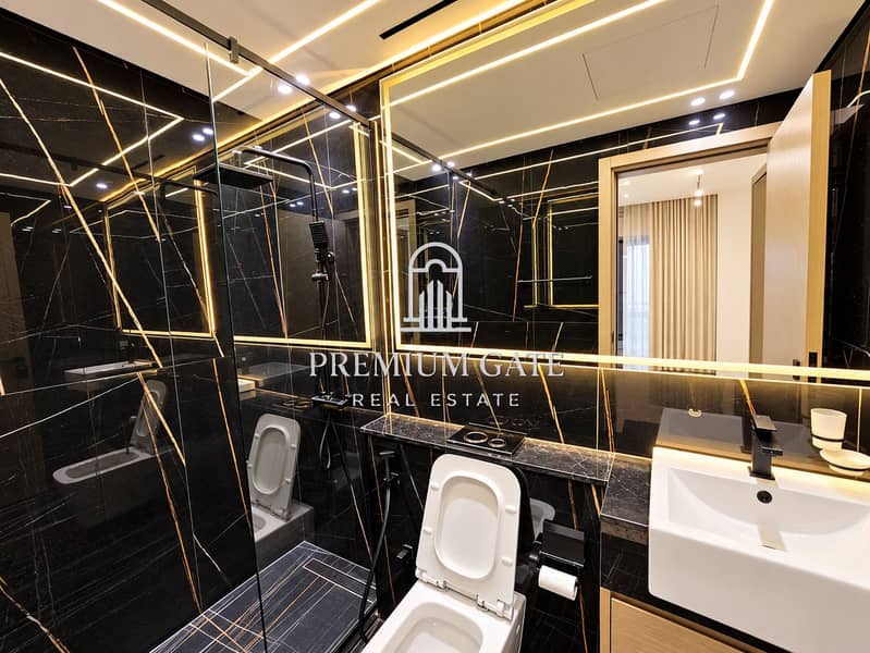 7 Modern Black Marble Bathroom with Warm Lighting. png