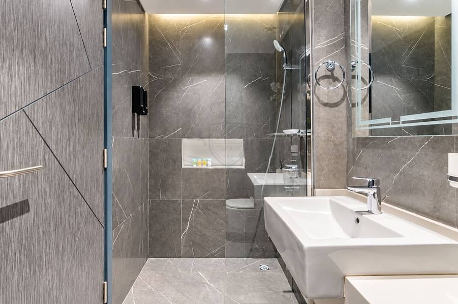 13 Modern Marble Bathroom with Glass Shower. png