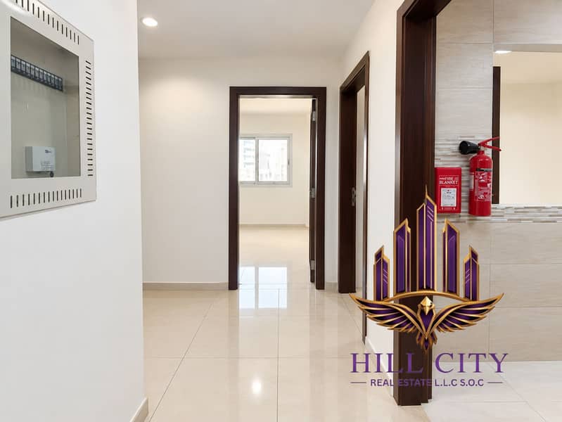 2 Bright Modern Hallway with Fire Safety Gear. png