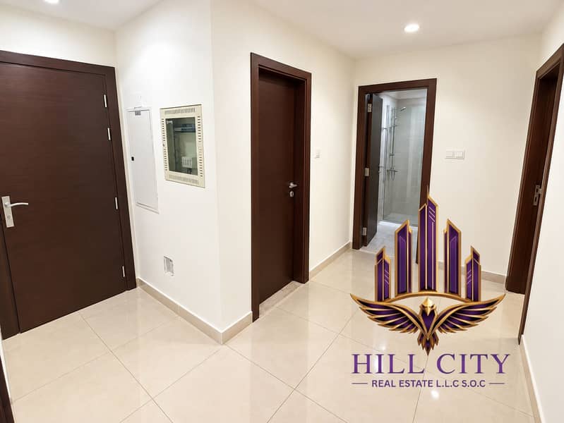 6 Modern Cream-Tiled Hallway with Dark Wood Doors. png