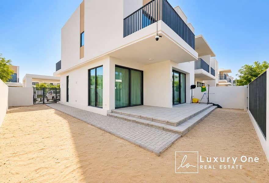 2 Sunlit Modern Villa Patio and Sandy Yard. png