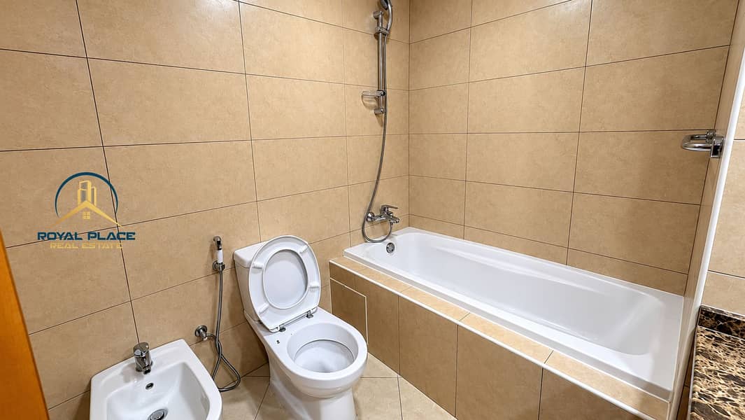 19 Modern Beige Tiled Bathroom with Bathtub. png