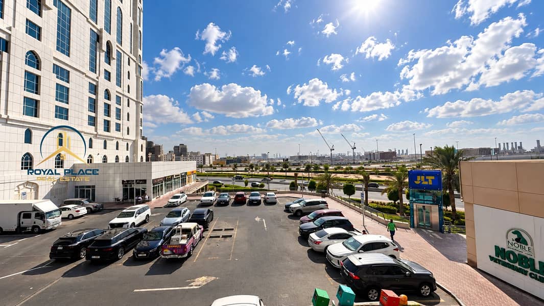 15 Sunny Urban Parking Lot with JLT Entrance. png