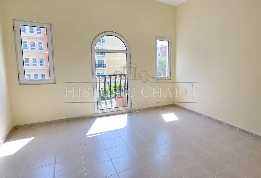 3 Sunlit Empty Apartment with Arched Balcony Door. png