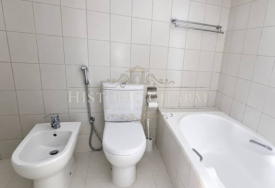 12 Minimalist White Tile Bathroom with Bidet and Bathtub. png