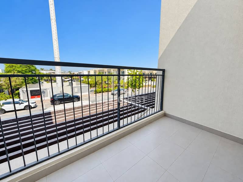 12 Sunny Modern Balcony Overlooking Landscaped Townhomes. png