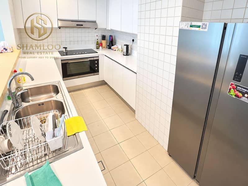 6 Bright Modern Galley Kitchen with Stainless Refrigerator. png