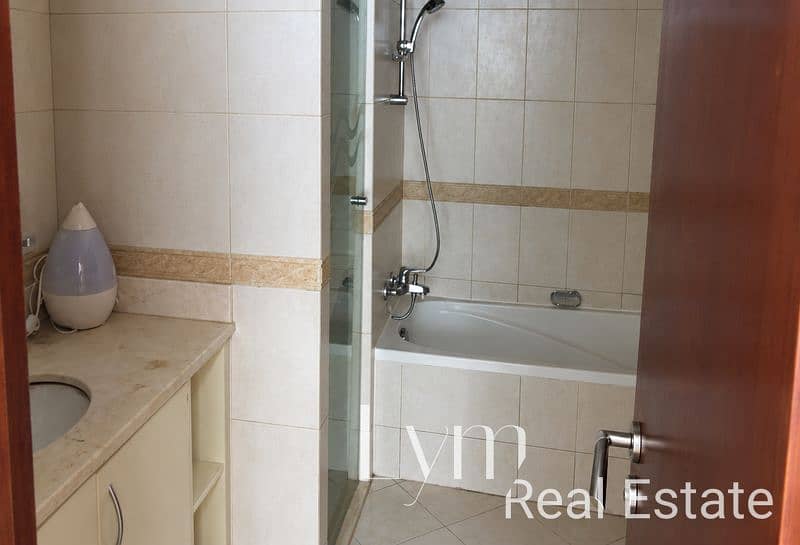 8 Cozy Beige Tiled Bathroom View. png