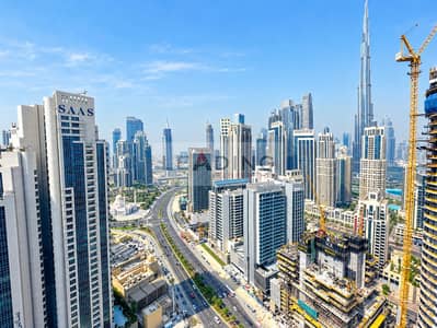 Office for Rent in Business Bay, Dubai - Dubai Skyline with Highways and Cranes. png