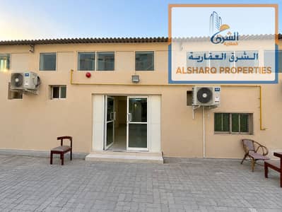 Labour Camp for Rent in Industrial Area, Sharjah - Symmetrical Beige Utility Building Facade. png