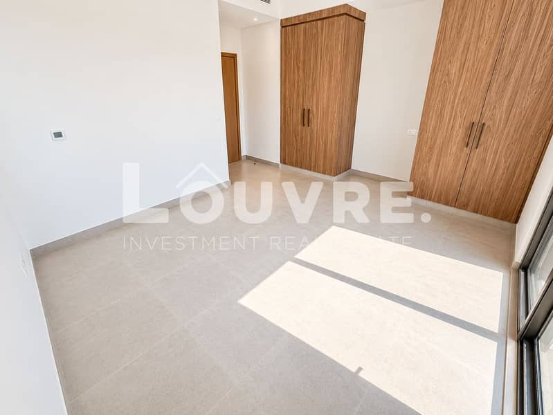 26 Sunlit Minimalist Room with Walnut Wardrobes. png