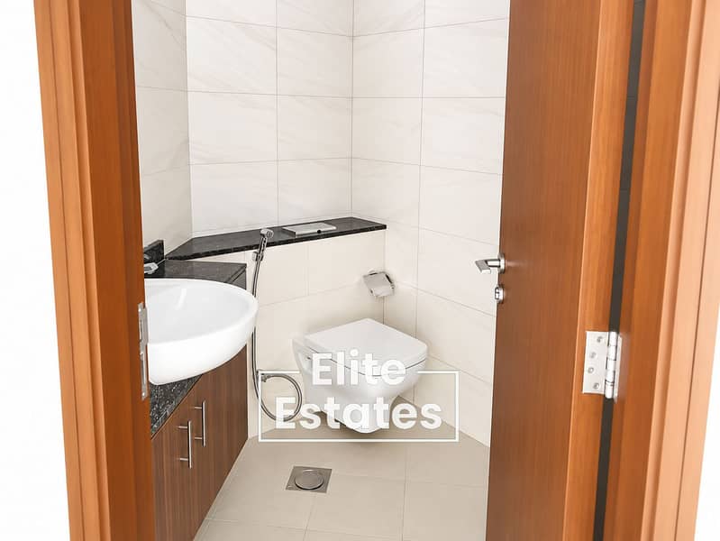 16 Modern Bathroom Framed by Wooden Door. png