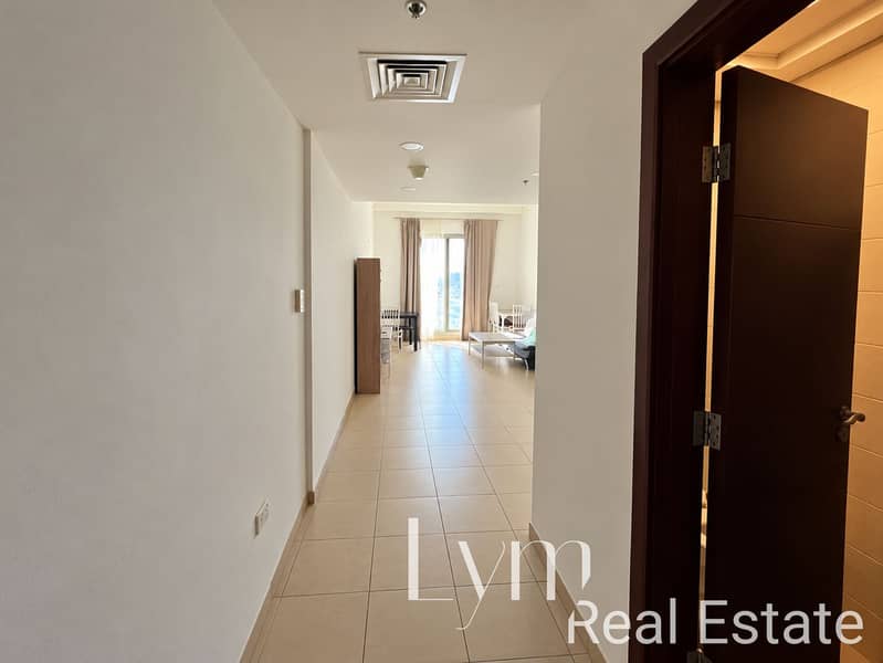 2 Hallway View into Bright Apartment Living Room. png