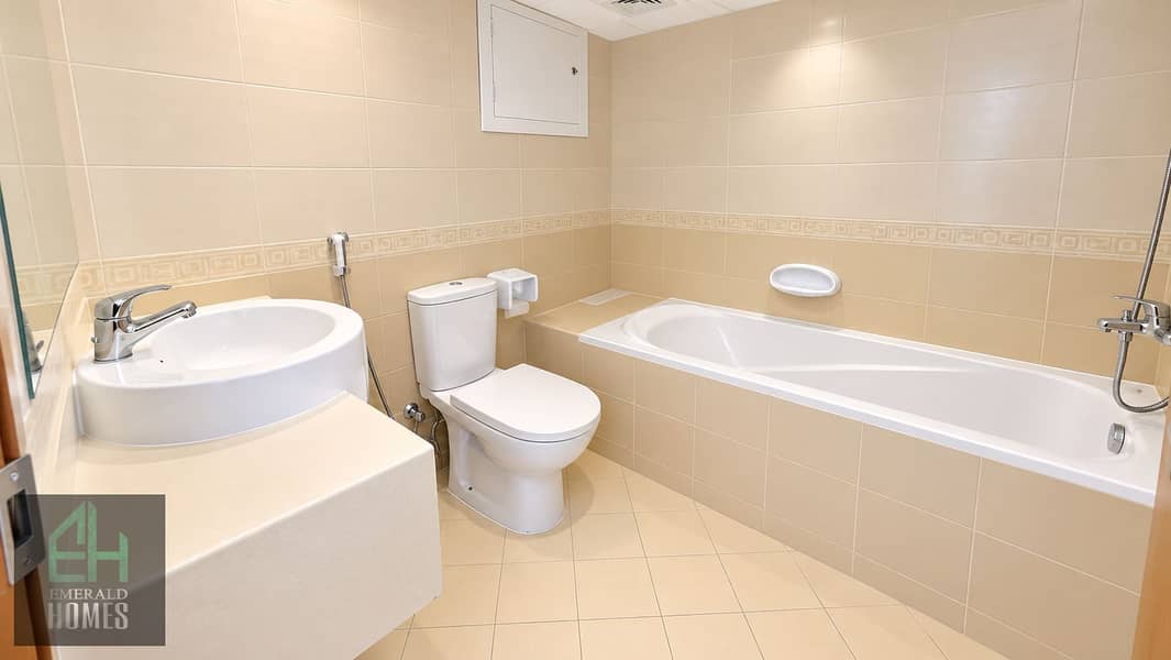 11 Clean Modern Beige Tiled Bathroom. png