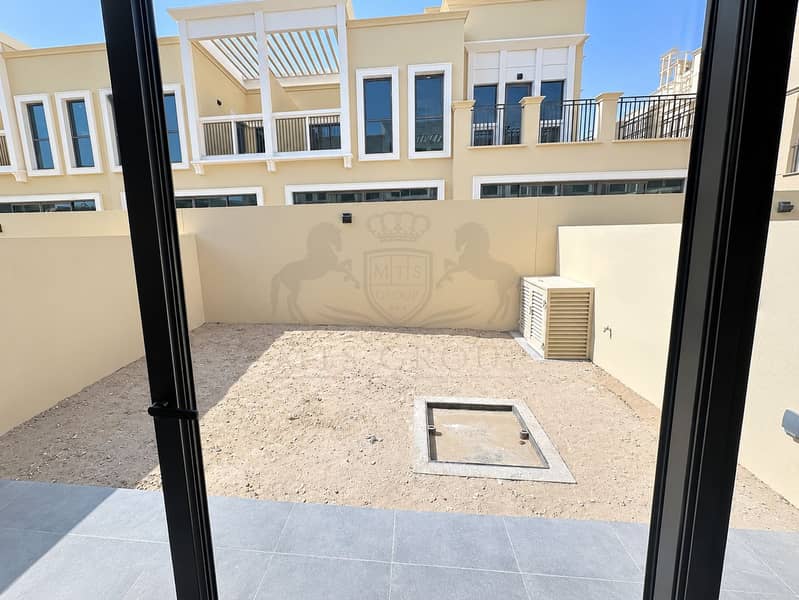 14 Sunlit Courtyard View Through Glass Doors. png