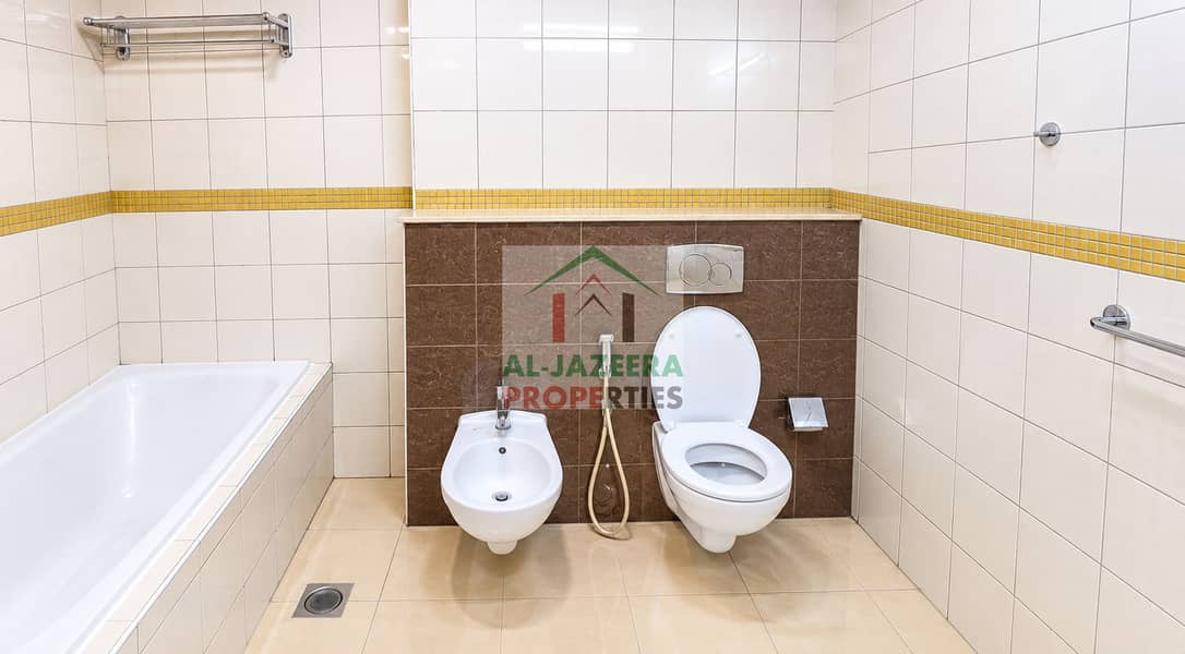 8 Modern Cream-Tiled Bathroom with Yellow Mosaic Accents. png