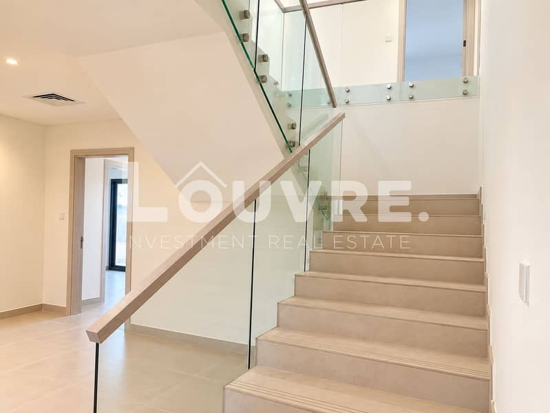 10 Minimalist Beige Stairwell with Glass Railings. png