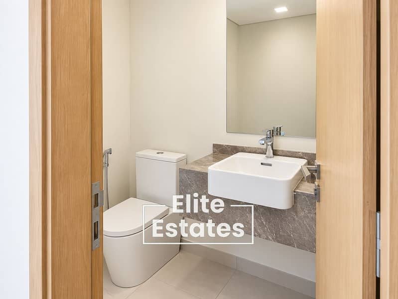 14 Modern Minimalist Bathroom Through a Wooden Door. png