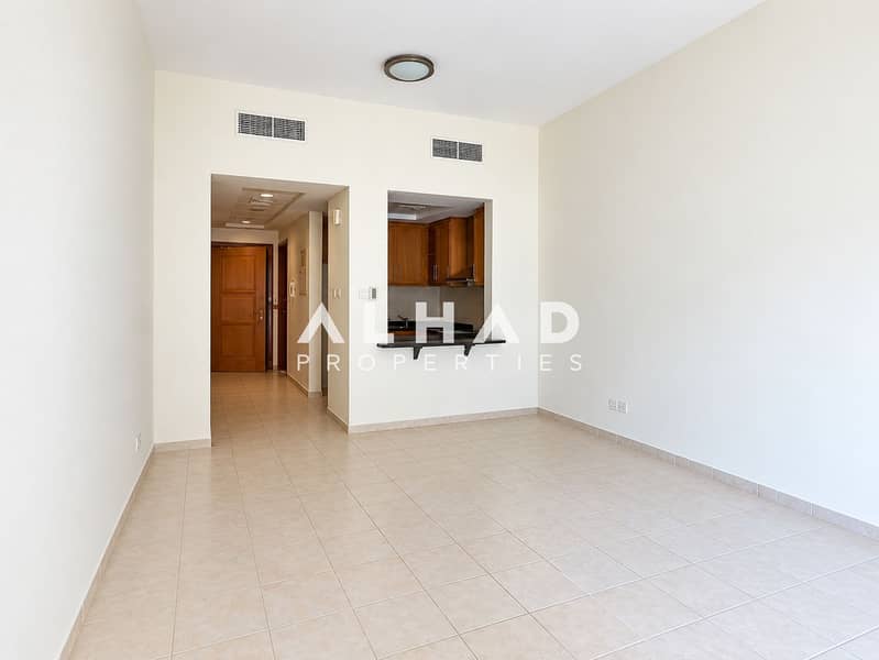 2 Empty Apartment Living Room with Kitchen Pass-Through. png