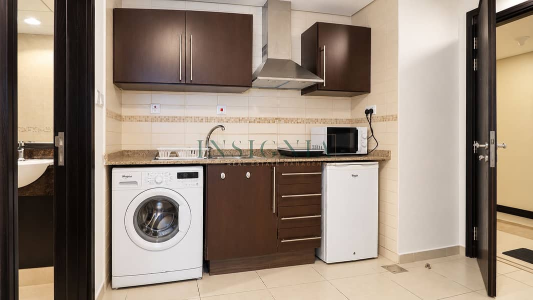 9 Compact Modern Kitchenette and Laundry Area. png