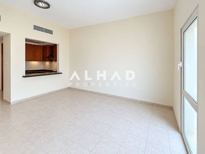2 Bright Vacant Living Room with Kitchen Pass-Through. png