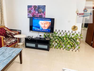 Appartement de 1 chambre à à louer à Al Nuaimiya, Ajman - Bright Living Room with TV and Green Trellis. png Appartement de 1 chambre à à louer à Al Nuaimiya, Ajman - Bright Living Room with TV and Green Trellis. png