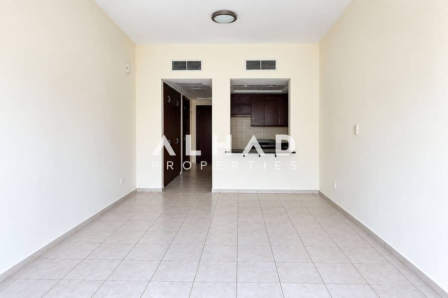 5 Empty Neutral Living Room with Kitchen Pass-Through. png