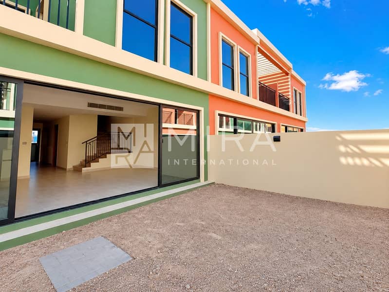9 Green courtyard, orange facade, open doors-4